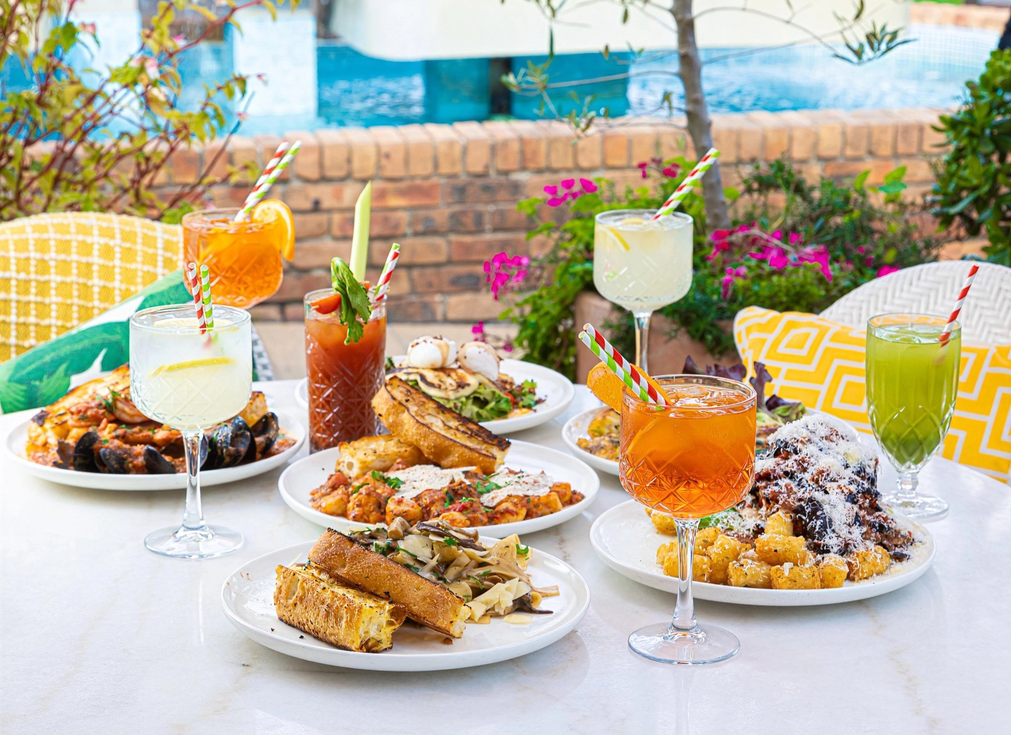 A colourful La Bottega table filled with food and drinks